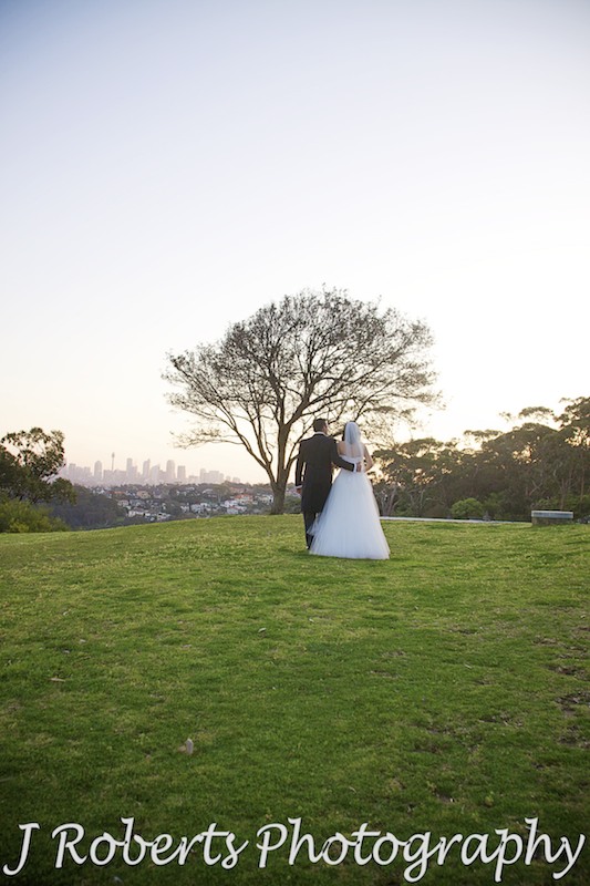 Bride and groom walking into the sunset at Georges Head Mosman - wedding photography sydney